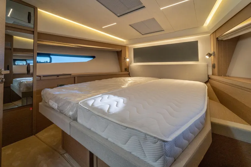  Yacht Photos Pics Luxurious bedroom interior of 2024 Prestige 520 yacht with modern lighting and elegant design.