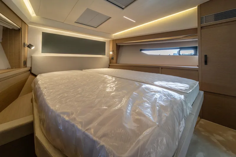 Yacht Photos Pics Luxurious bedroom interior of 2024 Prestige 520 yacht with modern design and ambient lighting.