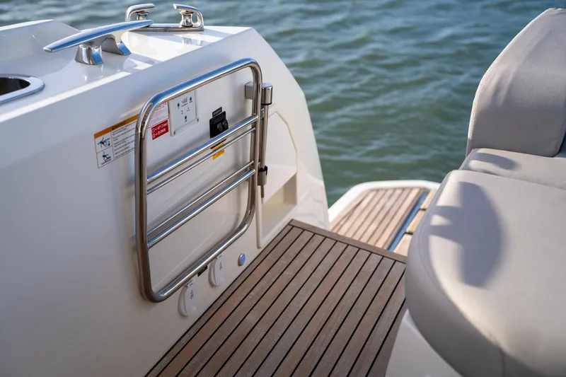  Yacht Photos Pics 2024 Prestige 520 yacht deck with stainless steel railing and cushioned seating.