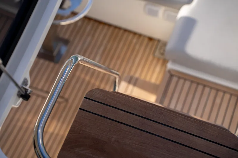  Yacht Photos Pics 2024 Prestige 520 yacht interior with wooden flooring and metal railing.