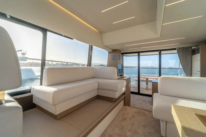  Yacht Photos Pics Luxurious interior of 2024 Prestige 520 yacht with panoramic windows and elegant seating.