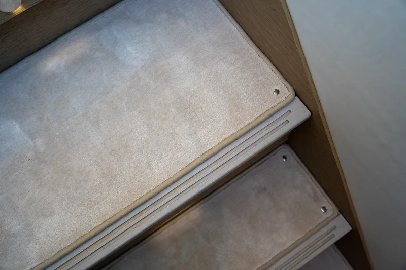  Yacht Photos Pics Carpeted stairs on a 2024 Prestige 520 yacht, featuring elegant design and craftsmanship.