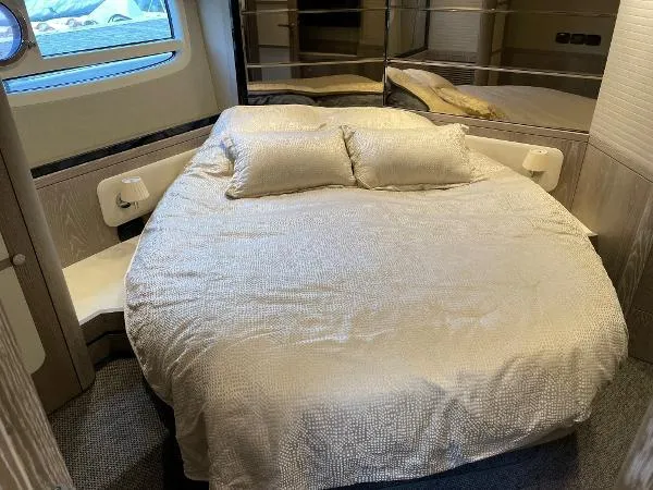 Azimut Magellano 53 Yacht Photos Pics Luxurious bedroom interior of 2020 Azimut Magellano 53 yacht with cozy bedding.