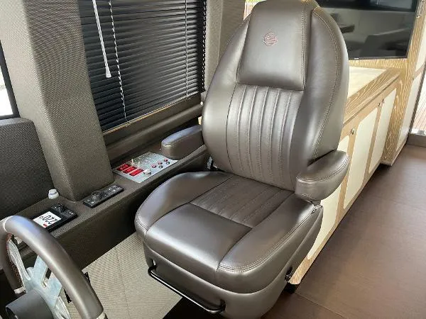 Azimut Magellano 53 Yacht Photos Pics Captain's chair in 2020 Azimut Magellano 53 yacht cockpit, featuring luxurious leather upholstery.