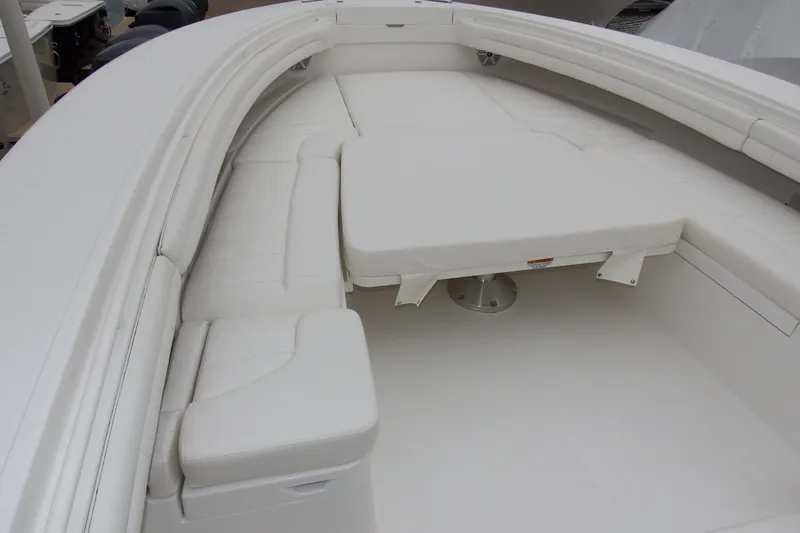  Yacht Photos Pics 2018 Regulator 34SS boat interior with white cushioned seating and table.