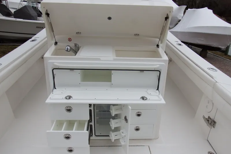  Yacht Photos Pics 2018 Regulator 34SS boat with open storage compartments and sink.