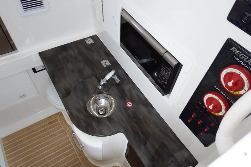  Yacht Photos Pics 2018 Regulator 34SS boat interior with sink, control panel, and microwave.