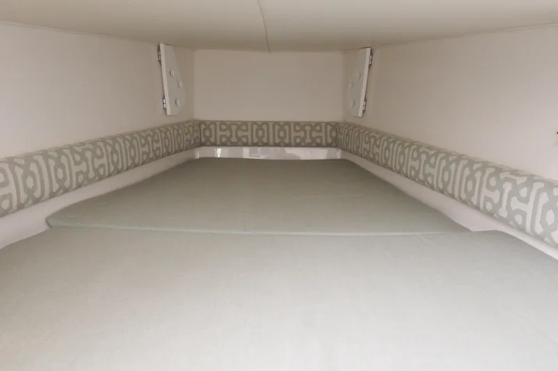  Yacht Photos Pics 2018 Regulator 34SS cabin interior with patterned cushions and neutral bedding.