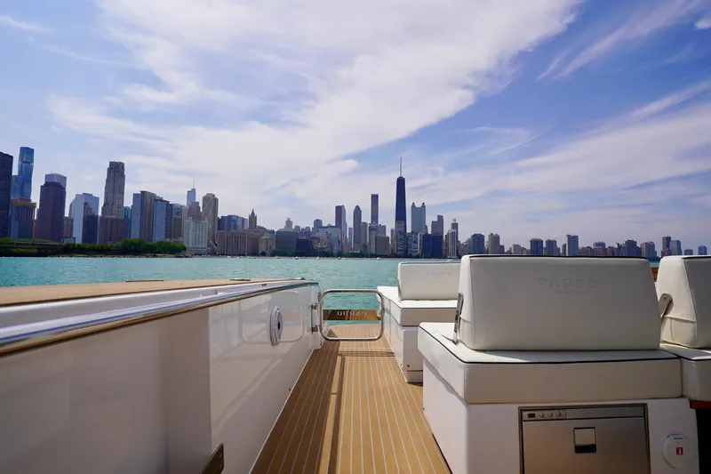  Yacht Photos Pics 2025 Pardo Yachts P43 cruising with city skyline view, clear skies, and calm waters.