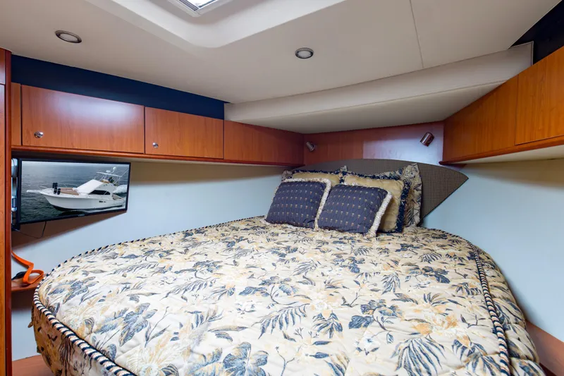 Pipe Dream Yacht Photos Pics Luxurious cabin interior of 2008 Luhrs 35 Convertible yacht with floral bedding and wood cabinetry.