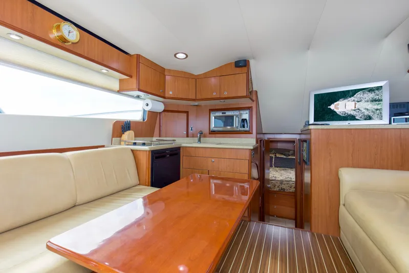 Pipe Dream Yacht Photos Pics Luxurious interior of 2008 Luhrs 35 Convertible yacht with modern kitchen and seating area.