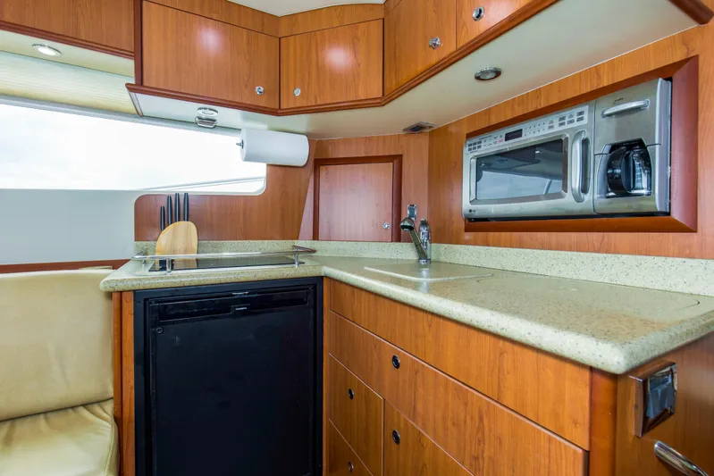 Pipe Dream Yacht Photos Pics 2008 Luhrs 35 Convertible yacht kitchen with wood cabinetry, sink, and built-in appliances.
