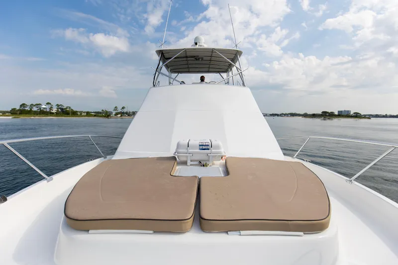 Pipe Dream Yacht Photos Pics 2008 Luhrs 35 Convertible yacht with sun pads on deck, cruising on calm waters.