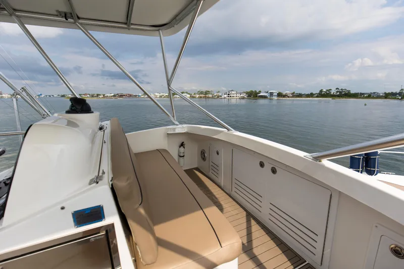 Pipe Dream Yacht Photos Pics 2008 Luhrs 35 Convertible boat deck with seating, overlooking calm waters and distant shoreline.