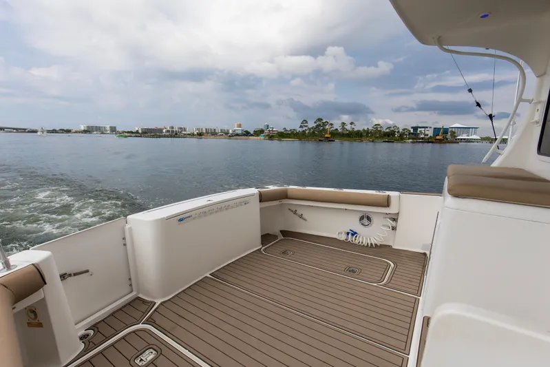 Pipe Dream Yacht Photos Pics 2008 Luhrs 35 Convertible boat deck with scenic waterfront view.