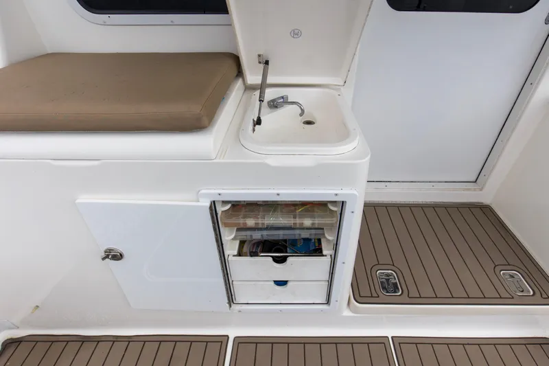 Pipe Dream Yacht Photos Pics 2008 Luhrs 35 Convertible boat interior with sink, storage, and cushioned seating.