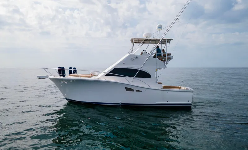 Pipe Dream Yacht Photos Pics 2008 Luhrs 35 Convertible yacht on calm ocean waters under cloudy sky.