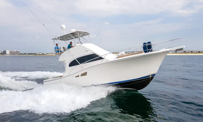 Pipe Dream Yacht Photos Pics 2008 Luhrs 35 Convertible yacht cruising on open water, with two people onboard.