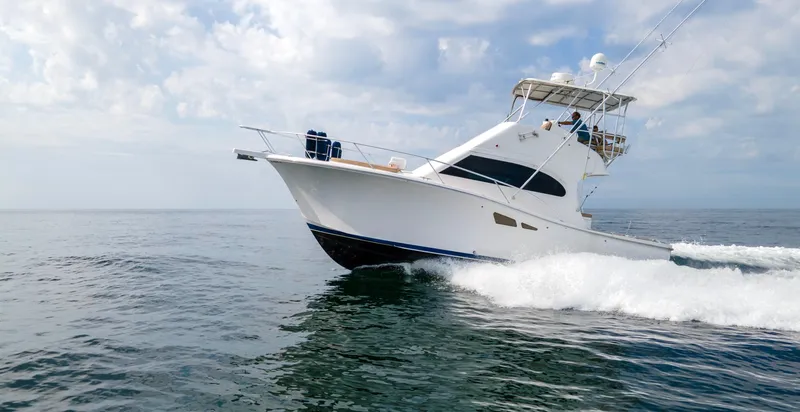 Pipe Dream Yacht Photos Pics 2008 Luhrs 35 Convertible yacht cruising on open water under a cloudy sky.