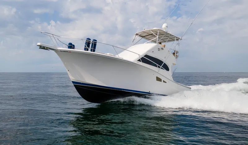 Pipe Dream Yacht Photos Pics 2008 Luhrs 35 Convertible yacht cruising on open water under a cloudy sky.