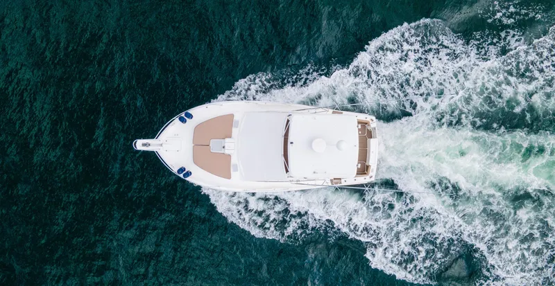 Pipe Dream Yacht Photos Pics Aerial view of 2008 Luhrs 35 Convertible yacht cruising through ocean waves.