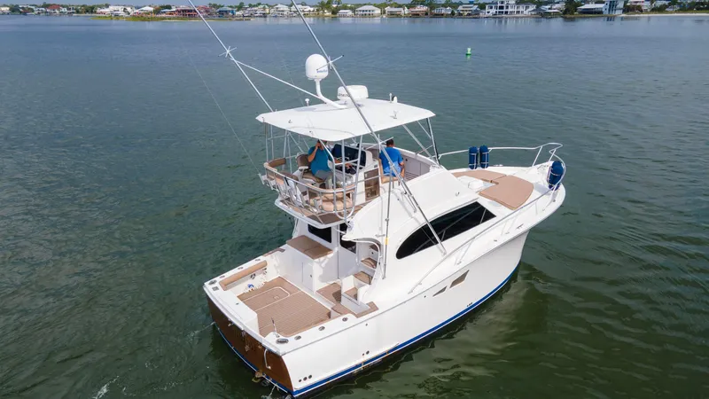 Pipe Dream Yacht Photos Pics 2008 Luhrs 35 Convertible boat cruising on calm waters, featuring a spacious deck and flybridge.