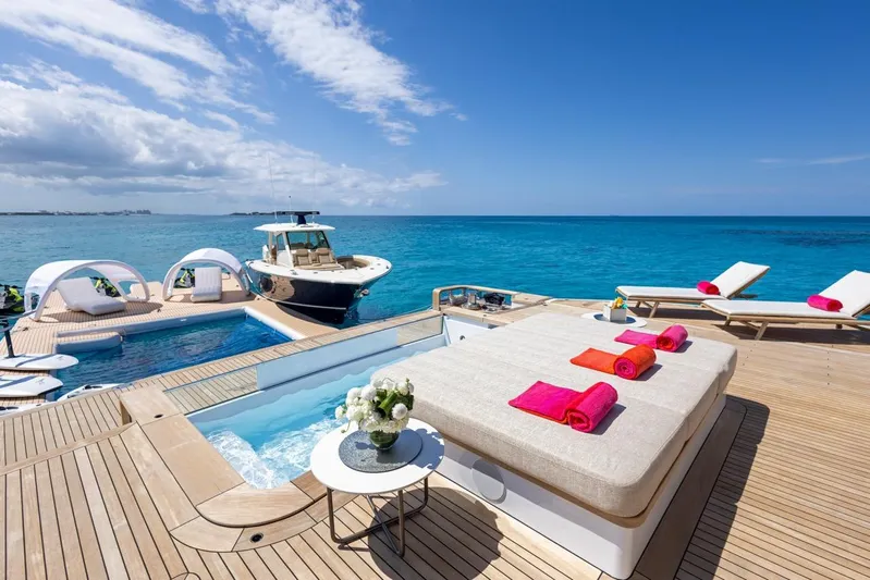 Contigo Yacht Photos Pics Luxurious 2024 Benetti 40M Oasis yacht deck with pool, sun loungers, and ocean view.