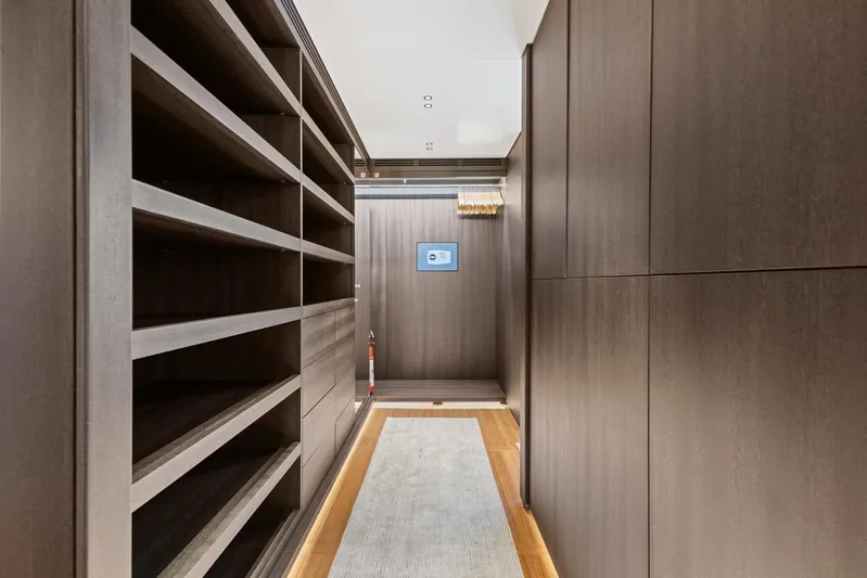 Contigo Yacht Photos Pics Luxurious interior of 2024 Benetti 40M Oasis yacht with elegant wood paneling and shelving.