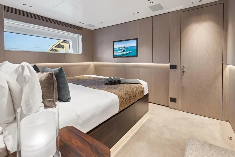 Contigo Yacht Photos Pics Luxurious bedroom interior of 2024 Benetti 40M Oasis yacht, featuring modern design and elegant furnishings.