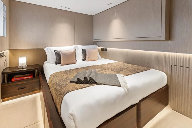 Contigo Yacht Photos Pics Luxurious bedroom interior on 2024 Benetti 40M Oasis yacht, featuring elegant design and cozy bedding.