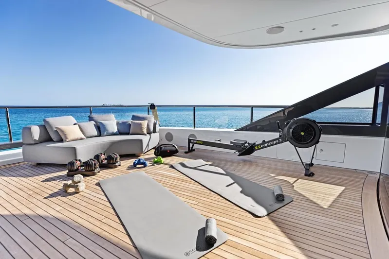 Contigo Yacht Photos Pics Luxurious 2024 Benetti 40M Oasis yacht deck with fitness equipment and ocean view.