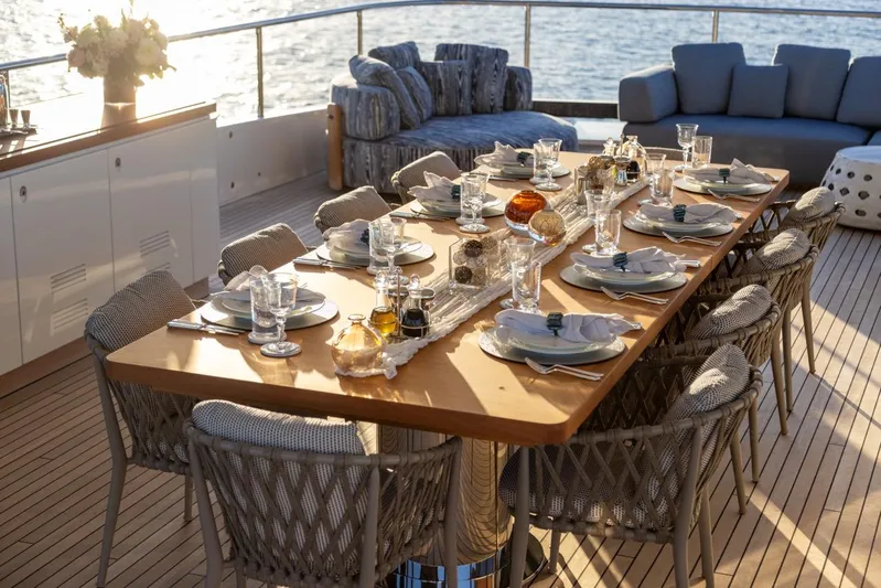 Contigo Yacht Photos Pics Luxurious dining setup on 2024 Benetti 40M Oasis yacht deck, overlooking the ocean.