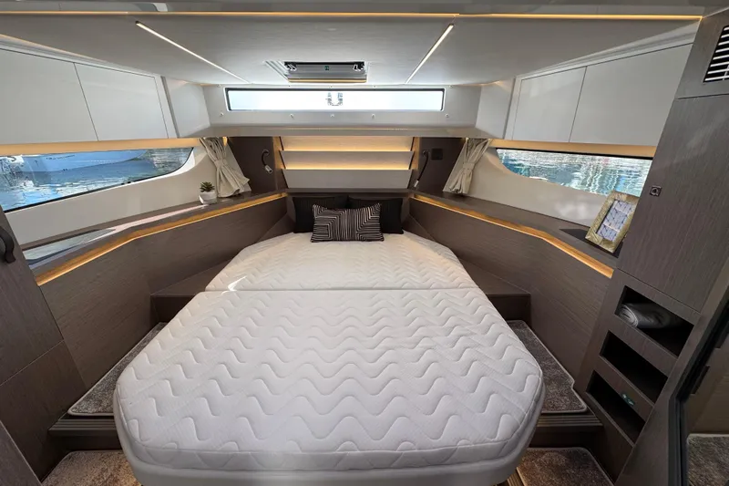  Yacht Photos Pics Luxurious bedroom interior of 2026 Jeanneau NC 1295 Coupe yacht with modern design.