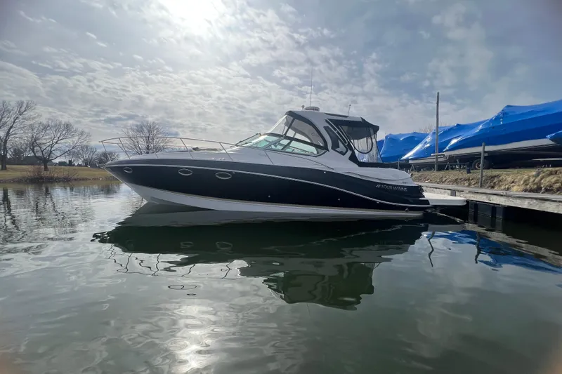  Yacht Photos Pics 2015 Four Winns 375 Vista boat docked on calm water under cloudy sky.