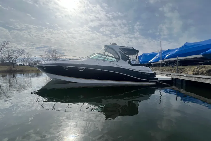  Yacht Photos Pics 2015 Four Winns 375 Vista boat docked on calm water under a cloudy sky.