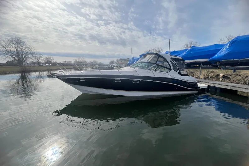  Yacht Photos Pics 2015 Four Winns 375 Vista boat docked on calm water under a cloudy sky.