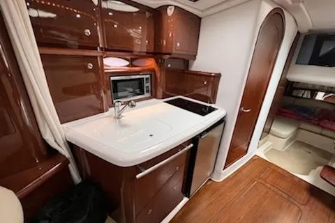  Yacht Photos Pics 2015 Four Winns 375 Vista yacht interior with kitchenette, sink, and microwave.
