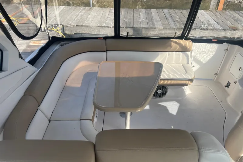  Yacht Photos Pics Interior seating area of 2015 Four Winns 375 Vista boat with table and cushioned seats.