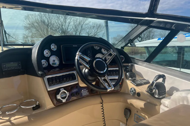  Yacht Photos Pics 2015 Four Winns 375 Vista boat helm with steering wheel and control panel.