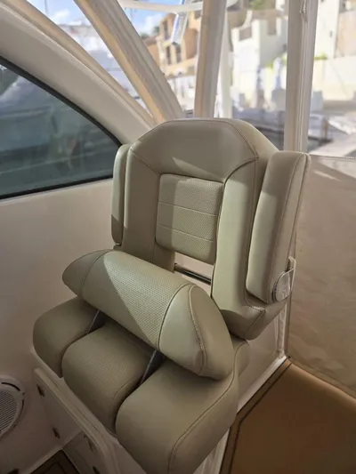 No Name Yacht Photos Pics 2019 Pursuit OS 385 Offshore boat seat, beige upholstery, interior view.