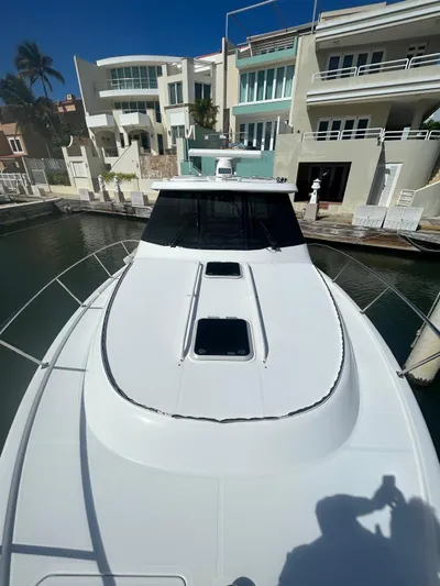 No Name Yacht Photos Pics 2019 Pursuit OS 385 Offshore yacht docked near modern waterfront homes.