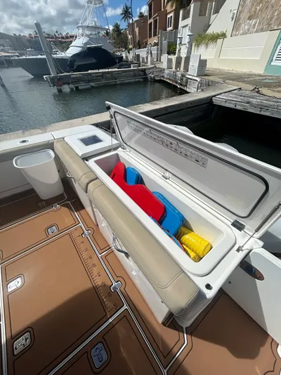 No Name Yacht Photos Pics 2019 Pursuit OS 385 Offshore boat with open storage compartment at marina.