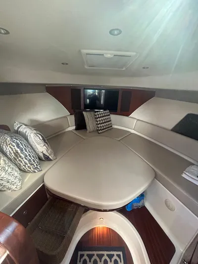 No Name Yacht Photos Pics 2019 Pursuit OS 385 Offshore cabin interior with plush seating and decorative pillows.