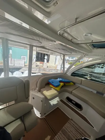 No Name Yacht Photos Pics 2019 Pursuit OS 385 Offshore interior with beige seating and colorful life jackets.