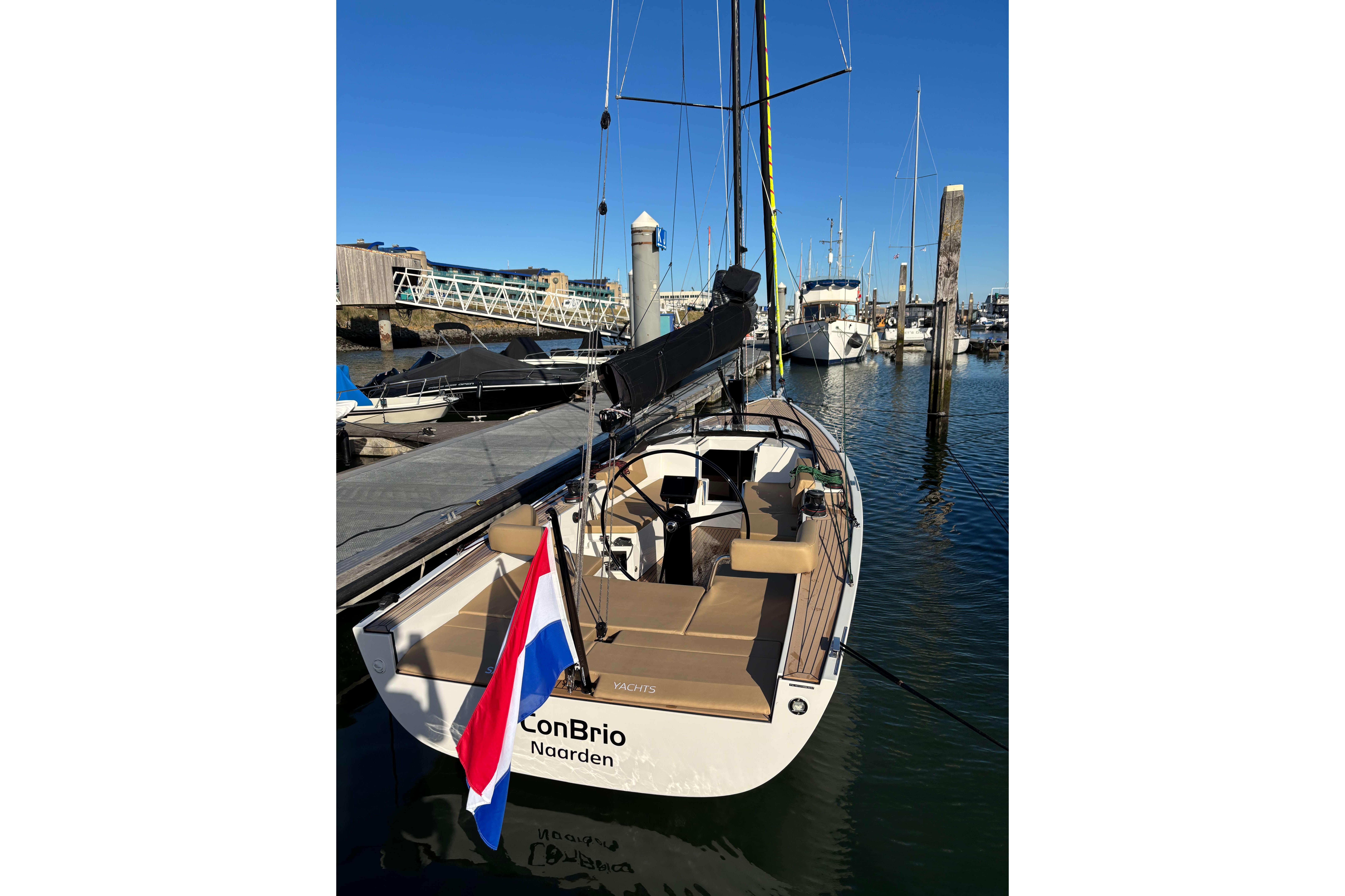 2023 Saffier Se 27 Leisure yacht docked in a marina, featuring sleek design and Dutch flag.