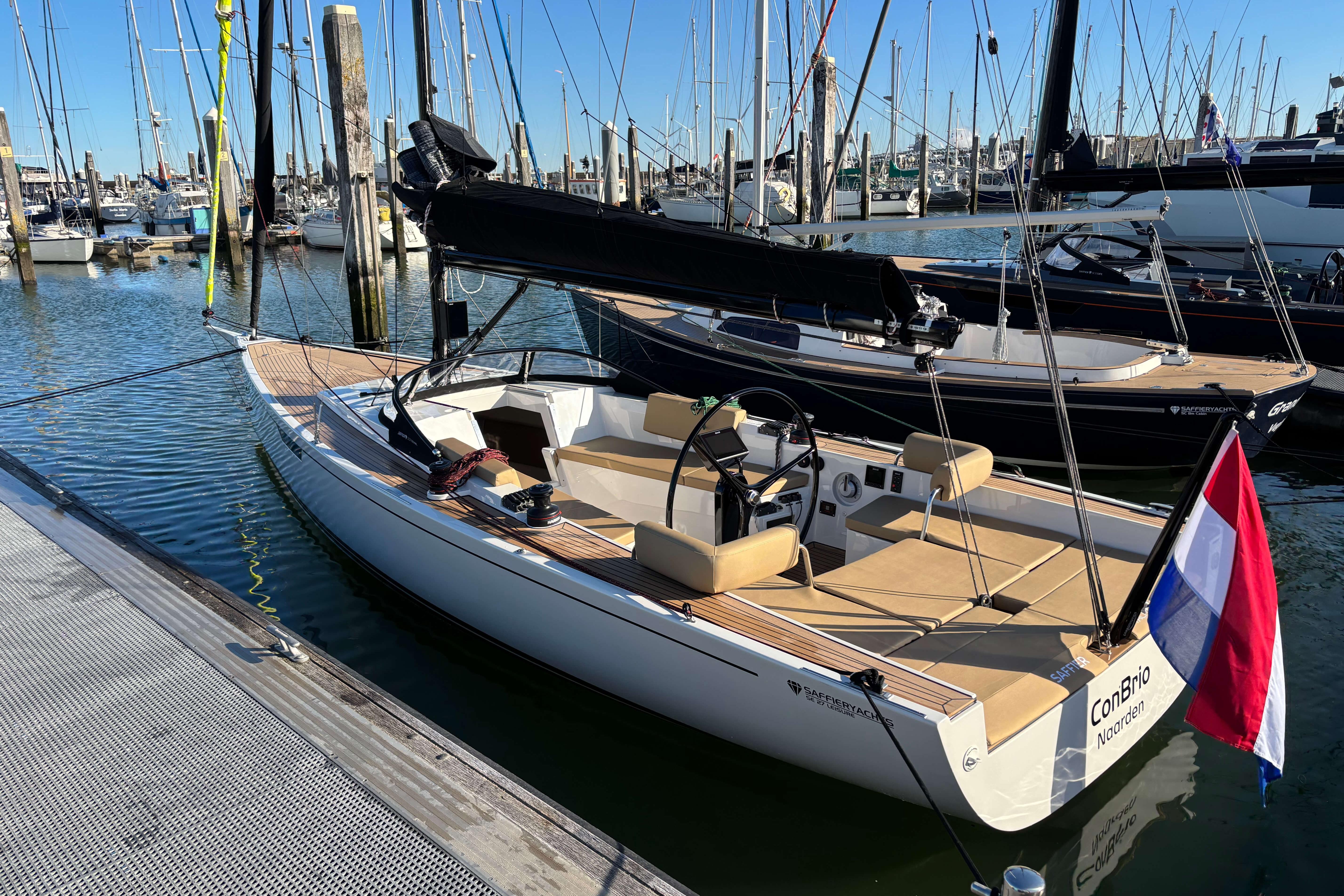 2023 Saffier Se 27 Leisure sailboat docked in a marina, featuring sleek design and Dutch flag.