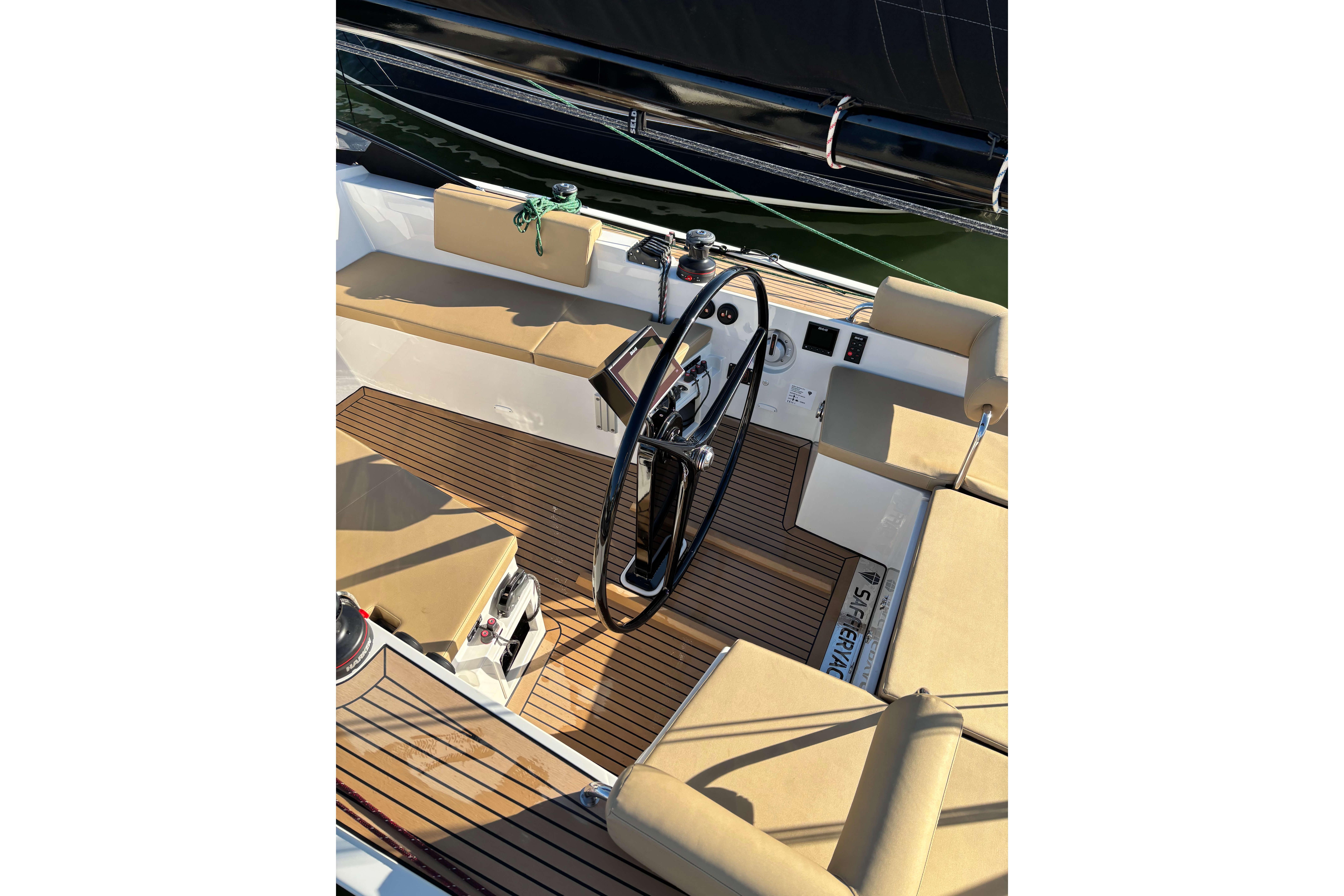 2023 Saffier Se 27 Leisure sailboat cockpit with teak flooring and cushioned seating.