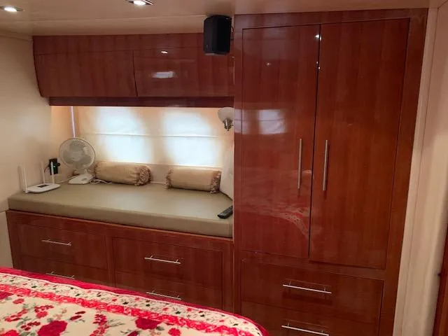  Yacht Photos Pics Luxurious interior of 2015 Regal 42 Sport Coupe with wooden cabinetry and cozy seating area.