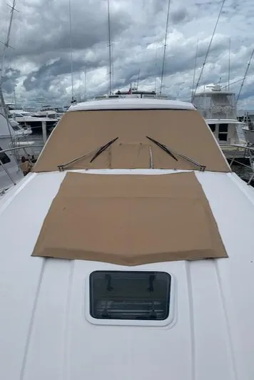  Yacht Photos Pics 2015 Regal 42 Sport Coupe yacht with tan covers docked at marina.
