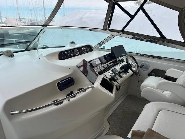 My Girl Yacht Photos Pics Interior helm of 1995 Sea Ray 450 Sundancer yacht with modern controls and seating.